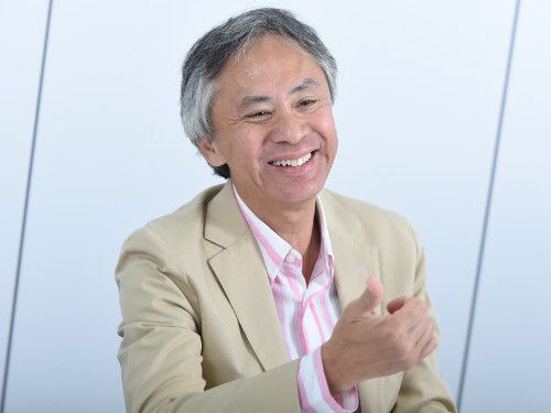 Patrick Lo smiling and gesturing during a 2015 interview