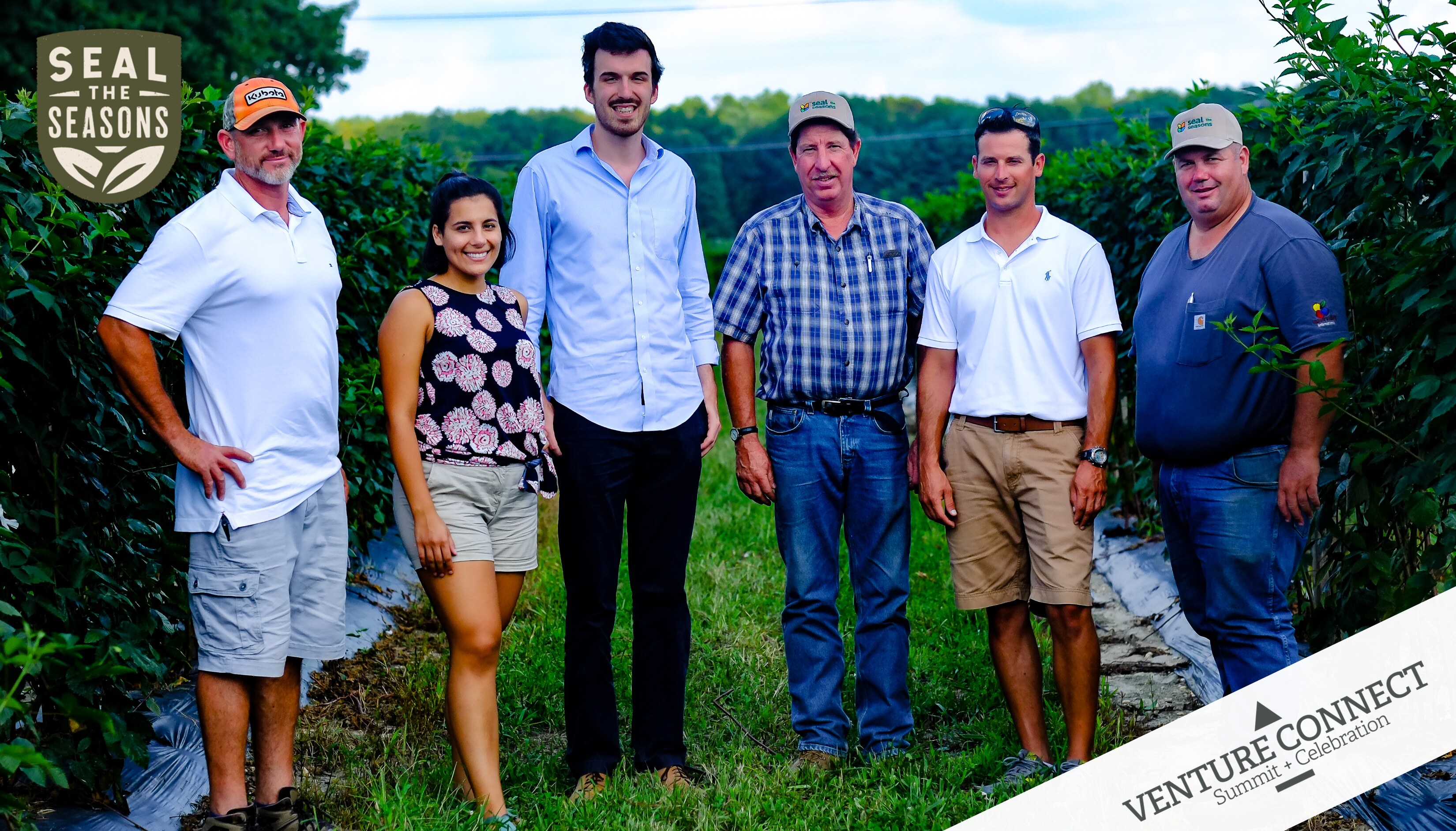 Patrick Mateer standing with Seal the Seasons colleagues and farm partners between rows of berry plants