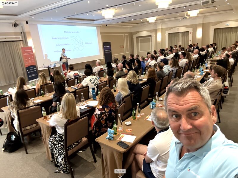 O’Connor taking a selfie with the Gatekeeper team seated behind him during a presentation