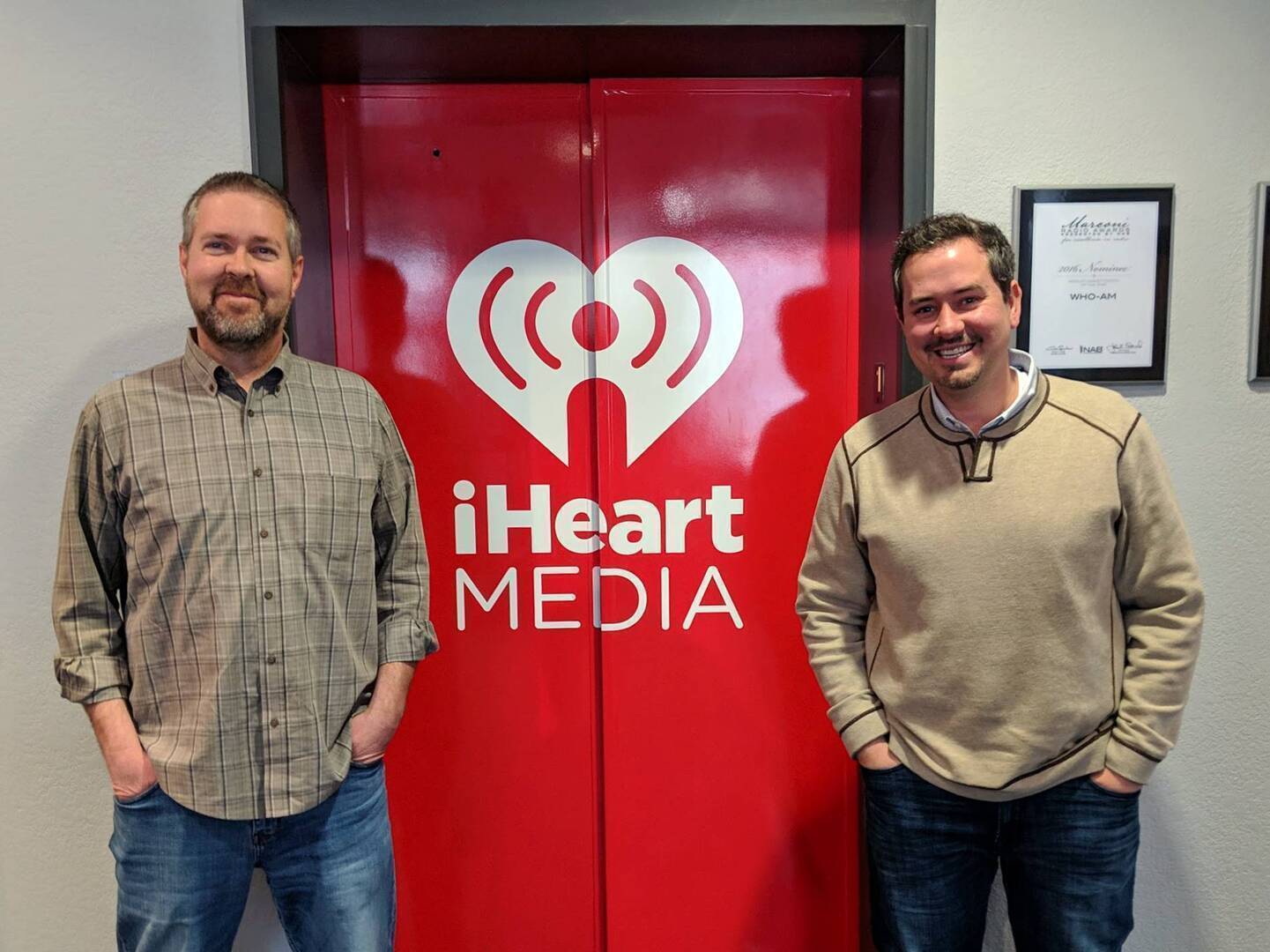 Paul Allen, left, standing with interviewer Justin Brady outside an iHeartMedia studio