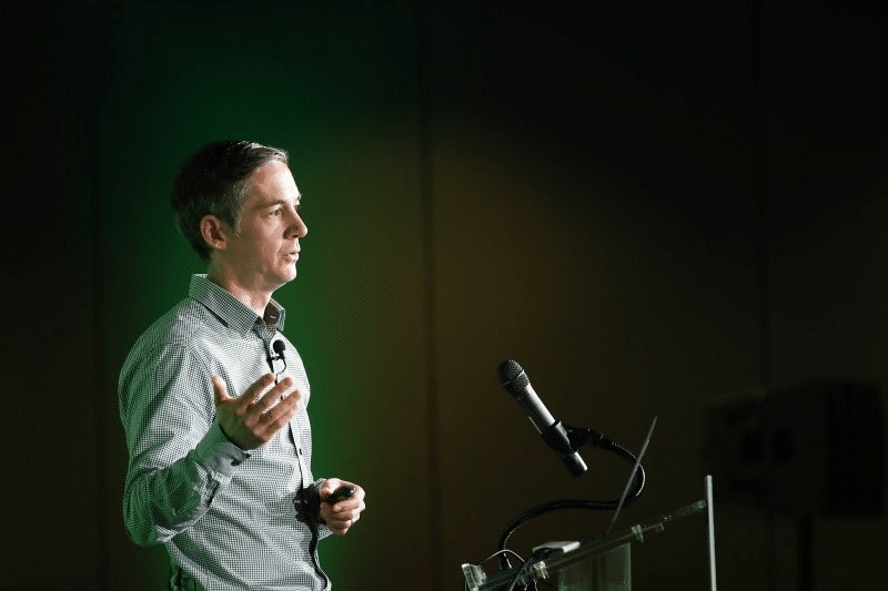 Paul Dix speaking at an InfluxData event beside a lectern