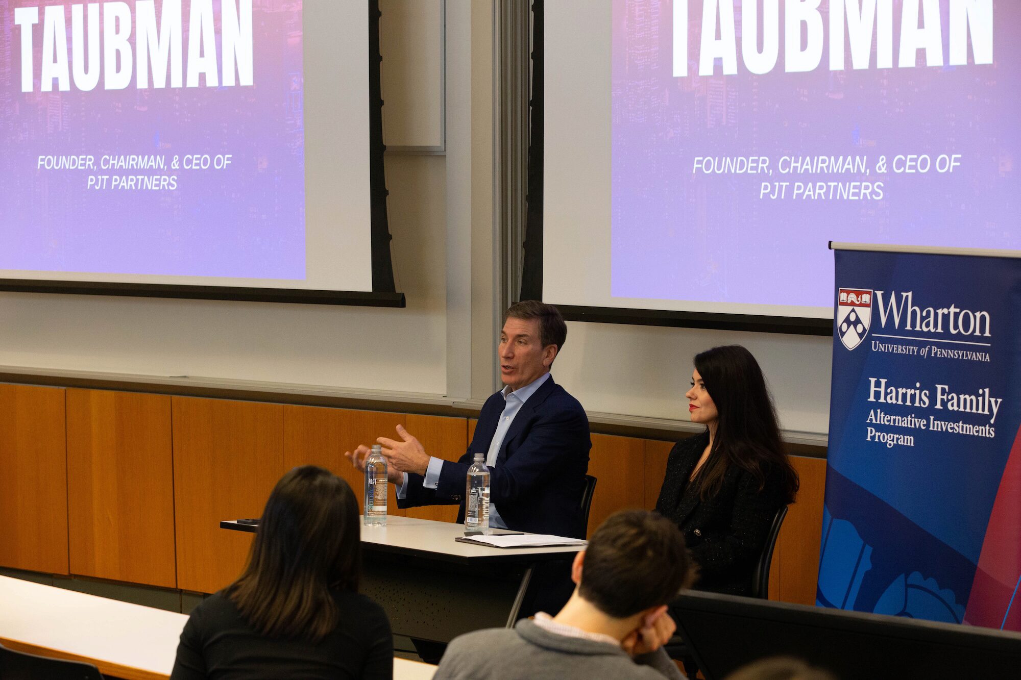 Paul Taubman speaking with Burcu Esmer before Wharton students