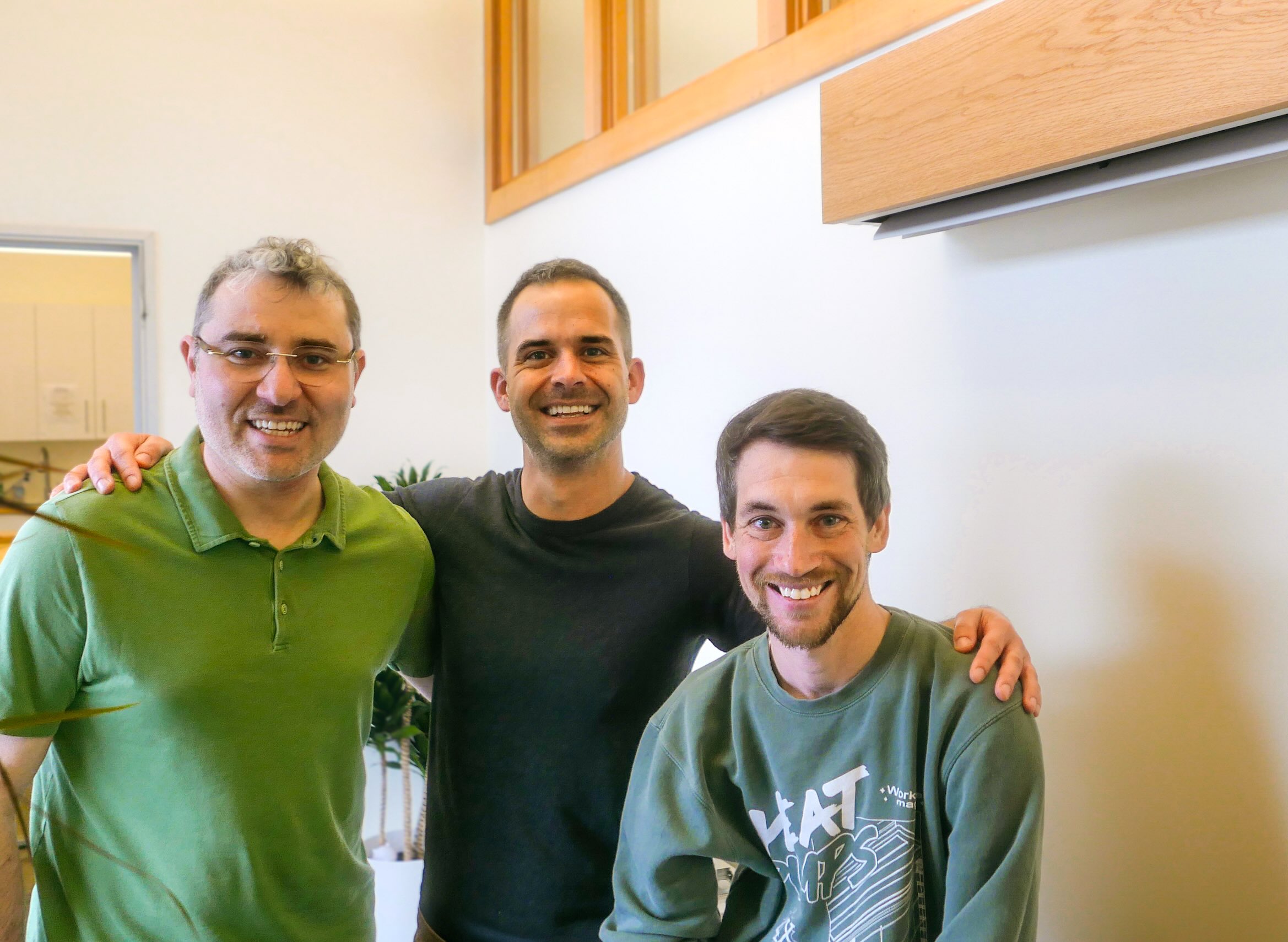 Paul Lambert with Matt Rogers and another Quilt co-founder beneath a wood-fronted indoor unit.