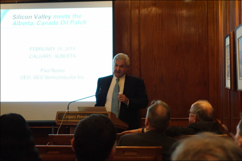 Paul Russo presenting at a lectern to guests at the Calgary Petroleum Club in 2014