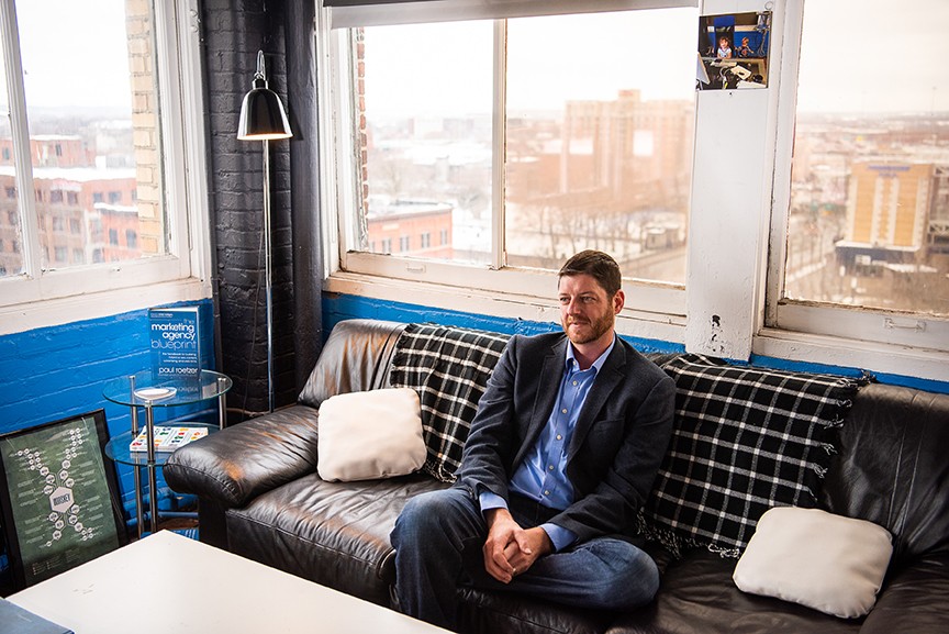 Paul Roetzer seated on a couch in his agency office