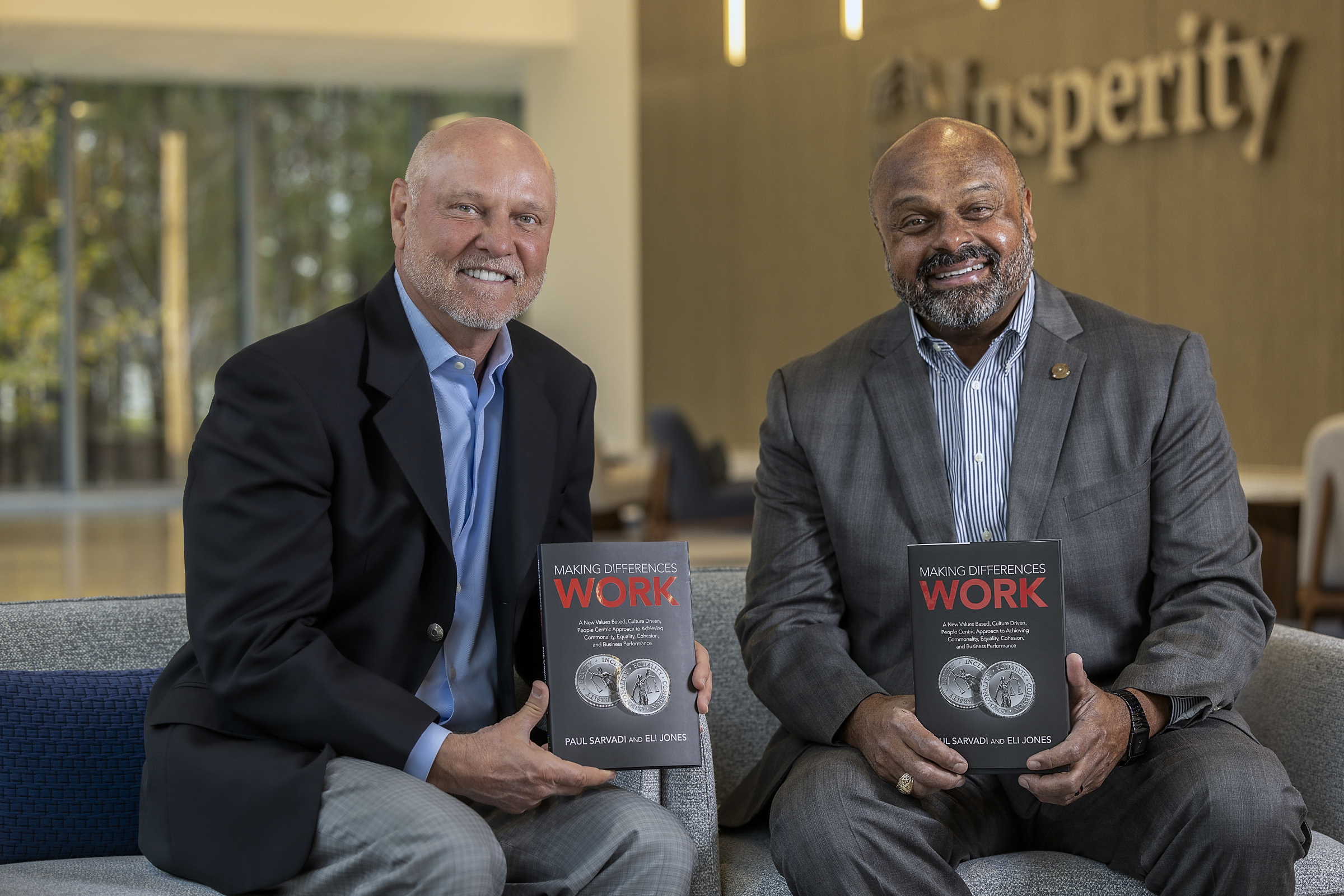 Paul Sarvadi, left, and Eli Jones seated together holding copies of Making Differences Work