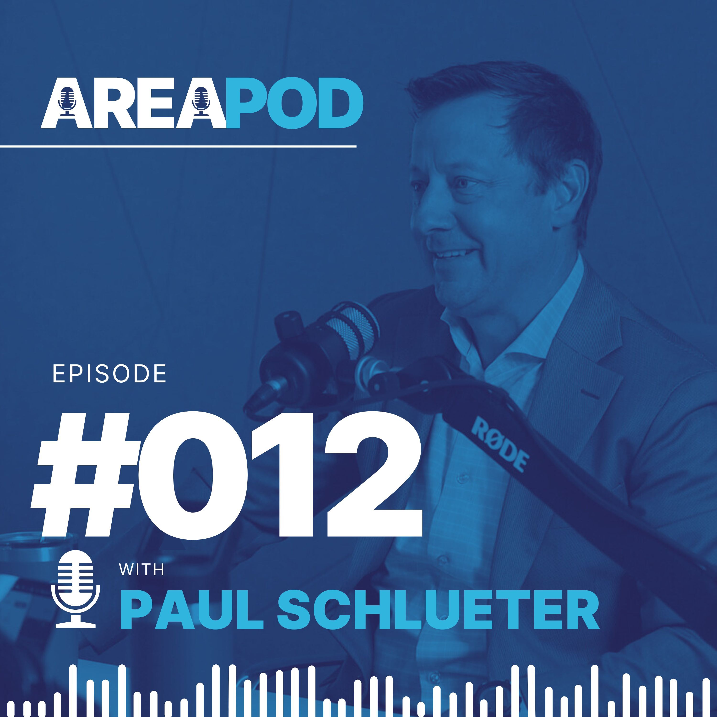Paul Schlueter at a microphone in the AREA Podcast’s episode 12 promotional image