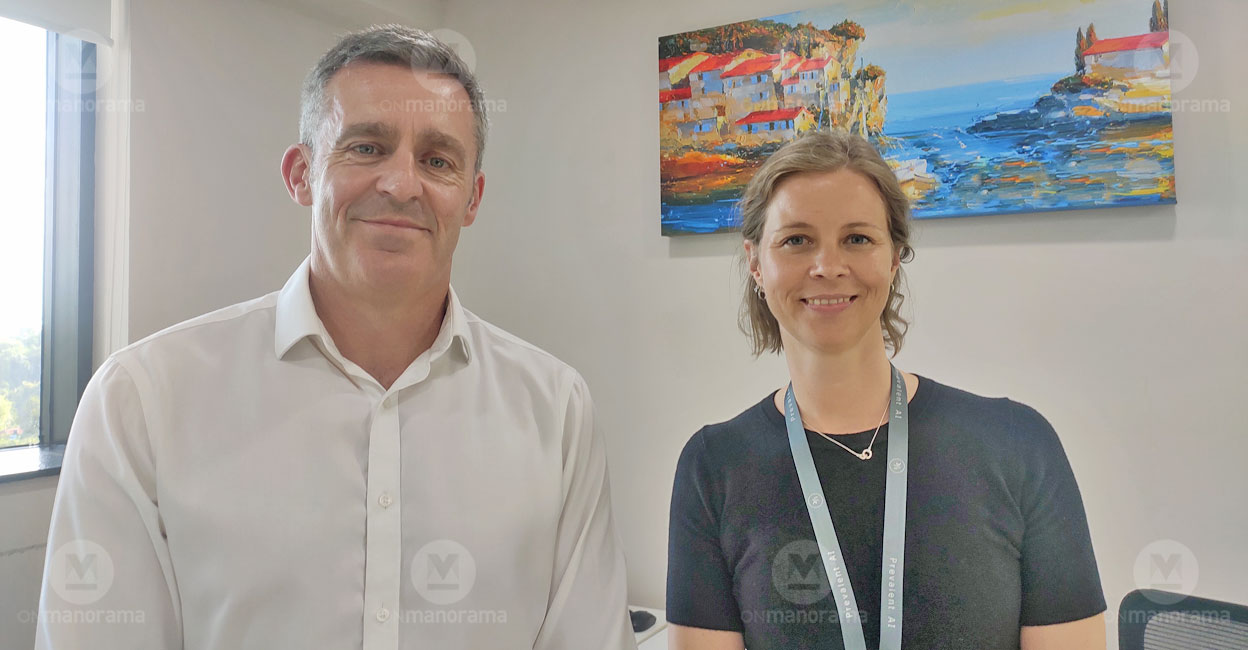 Paul Stokes and Sara Mottus standing together in the Kochi office