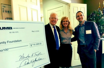 Tim Jackson, Tracy Ulmer and Paul Williamson, at right, with a community donation check in May 2018