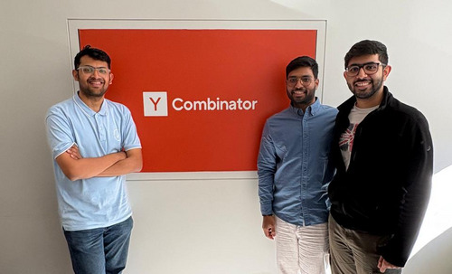 The three Ritivel cofounders standing in front of a Y Combinator sign
