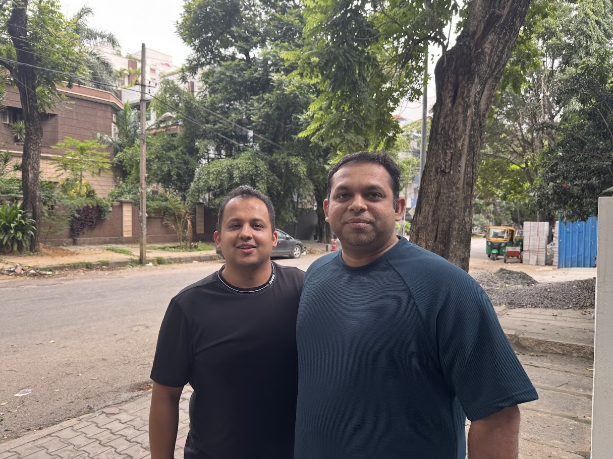 Coreworks co-founders Pavan Sondur on the left and Prashant Kumar on the right, standing together on a tree-lined street