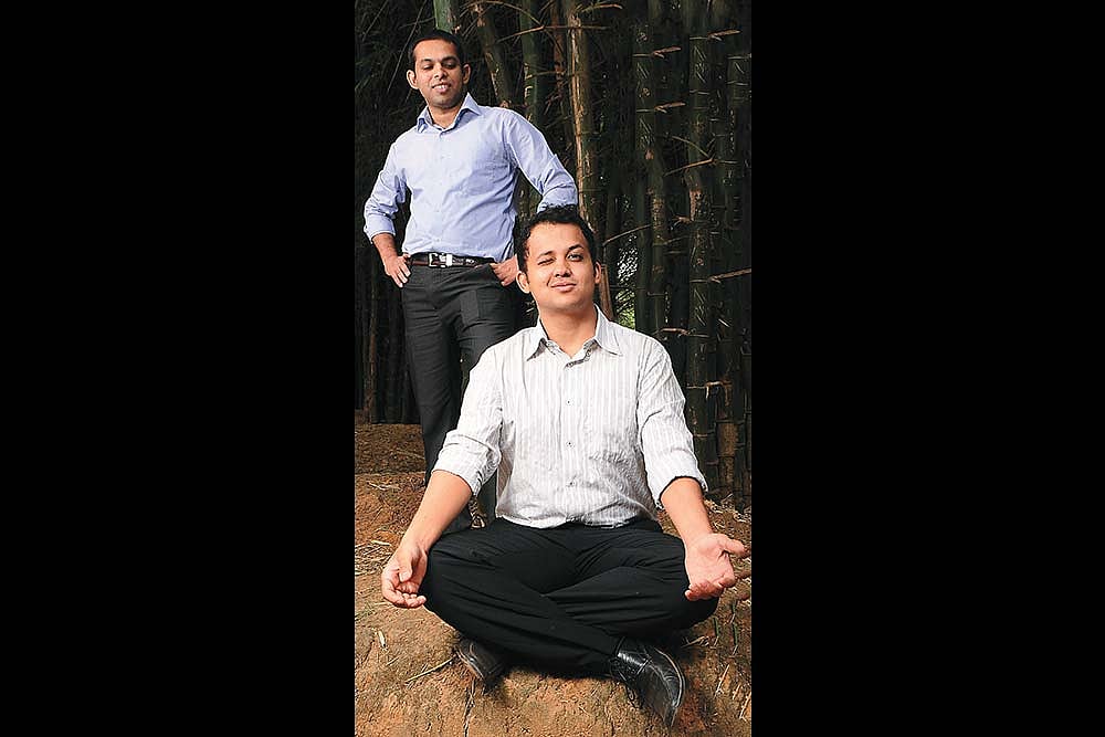 Pavan Sondur seated in the foreground, with co-founder Prashant Kumar standing behind him among bamboo
