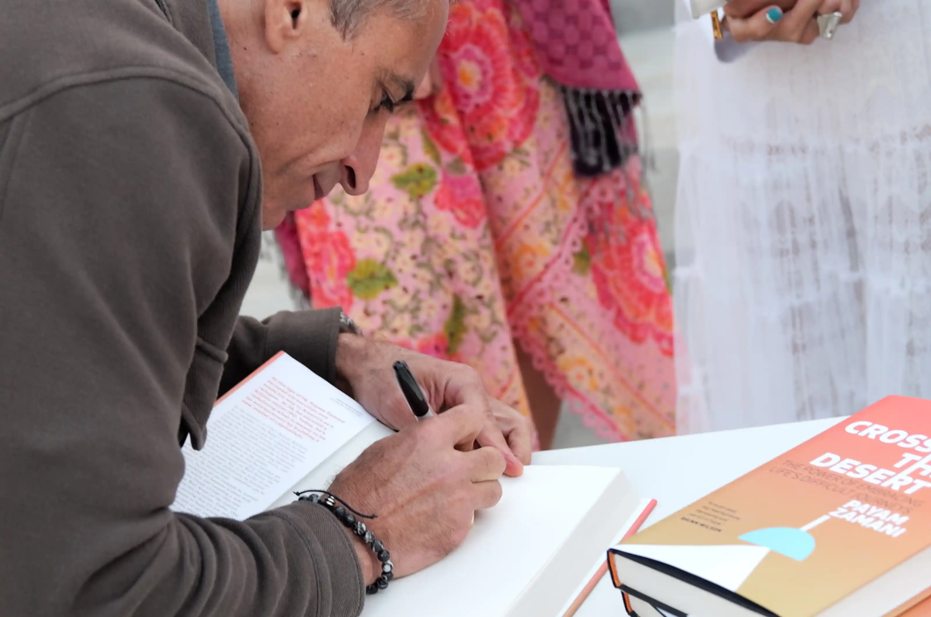 Payam Zamani signing copies of Crossing the Desert at its Los Angeles launch party