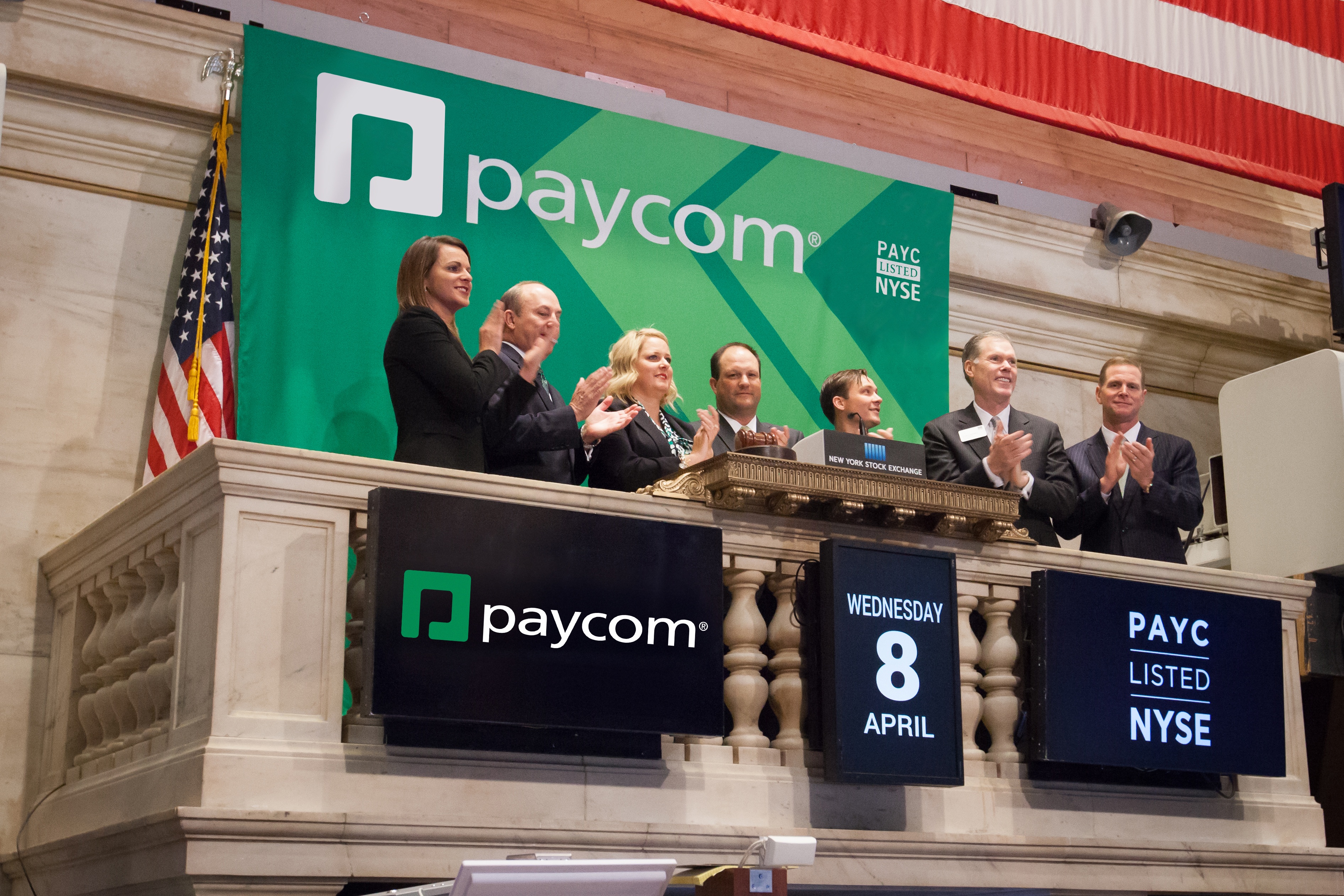 Paycom representatives celebrating the company’s listing at the New York Stock Exchange