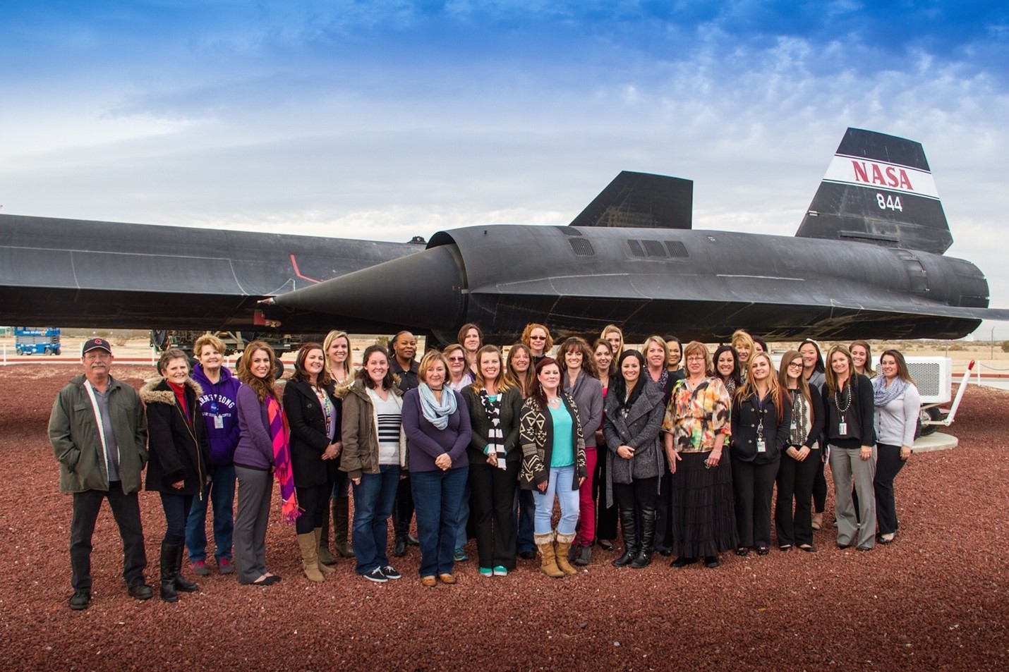 A large NASA support team gathered in front of an SR-71 aircraft