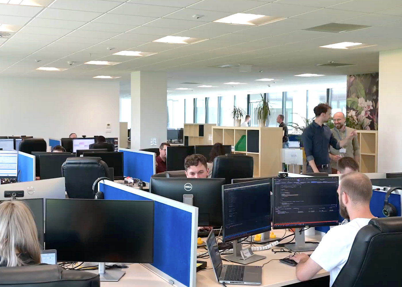 PCMI employees working at desks in the Kraków office
