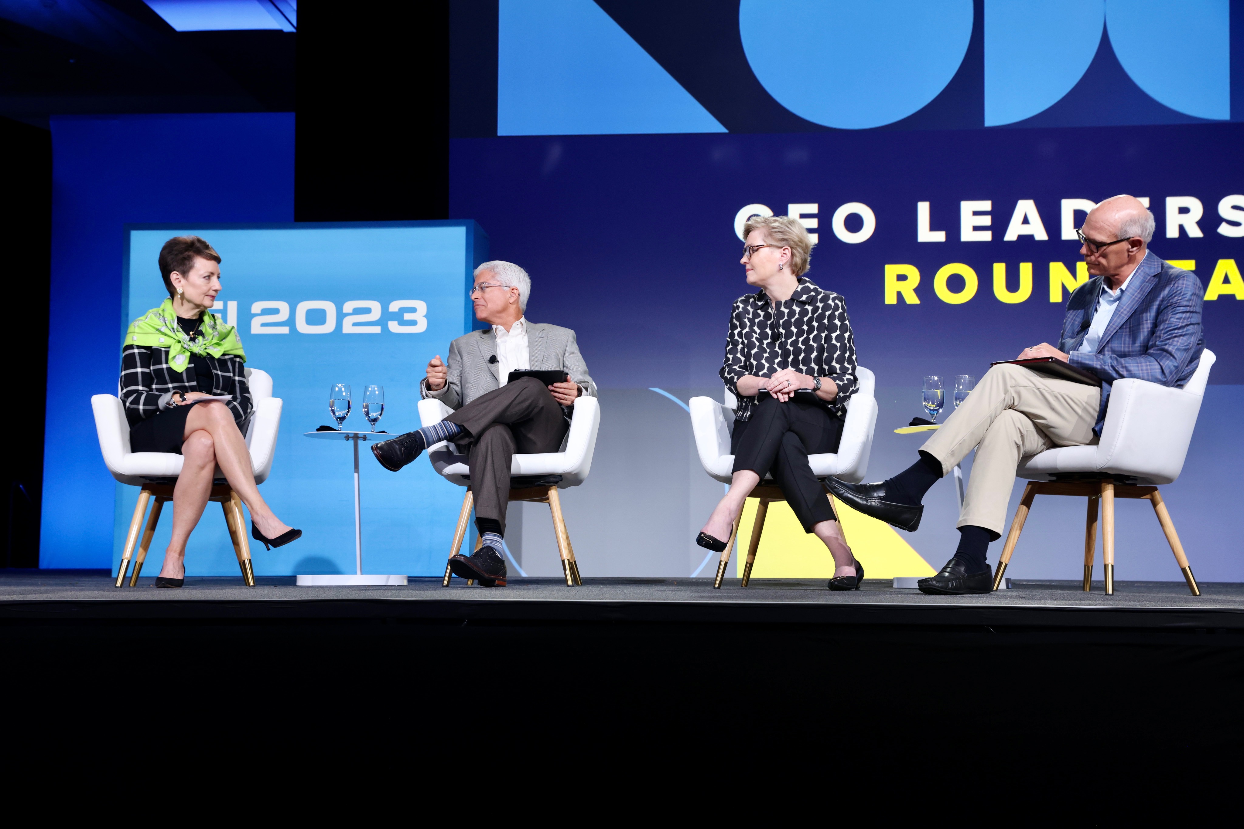 Lynn Good, Pedro Pizarro, Maria Pope and Warner Baxter seated on an EEI panel