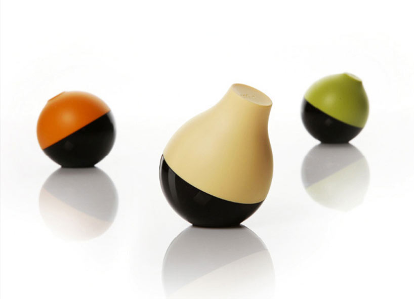 Three fruit-shaped Peel infrared remote accessories in orange, cream, and green