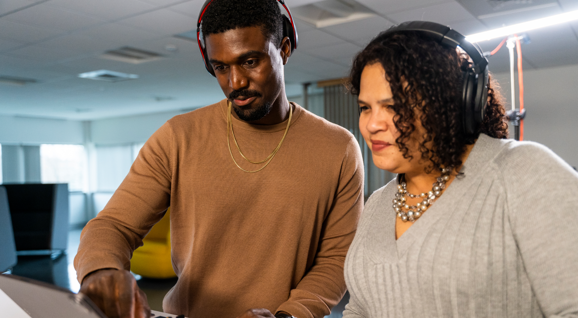 Two colleagues working together in a photograph from Pega’s careers site