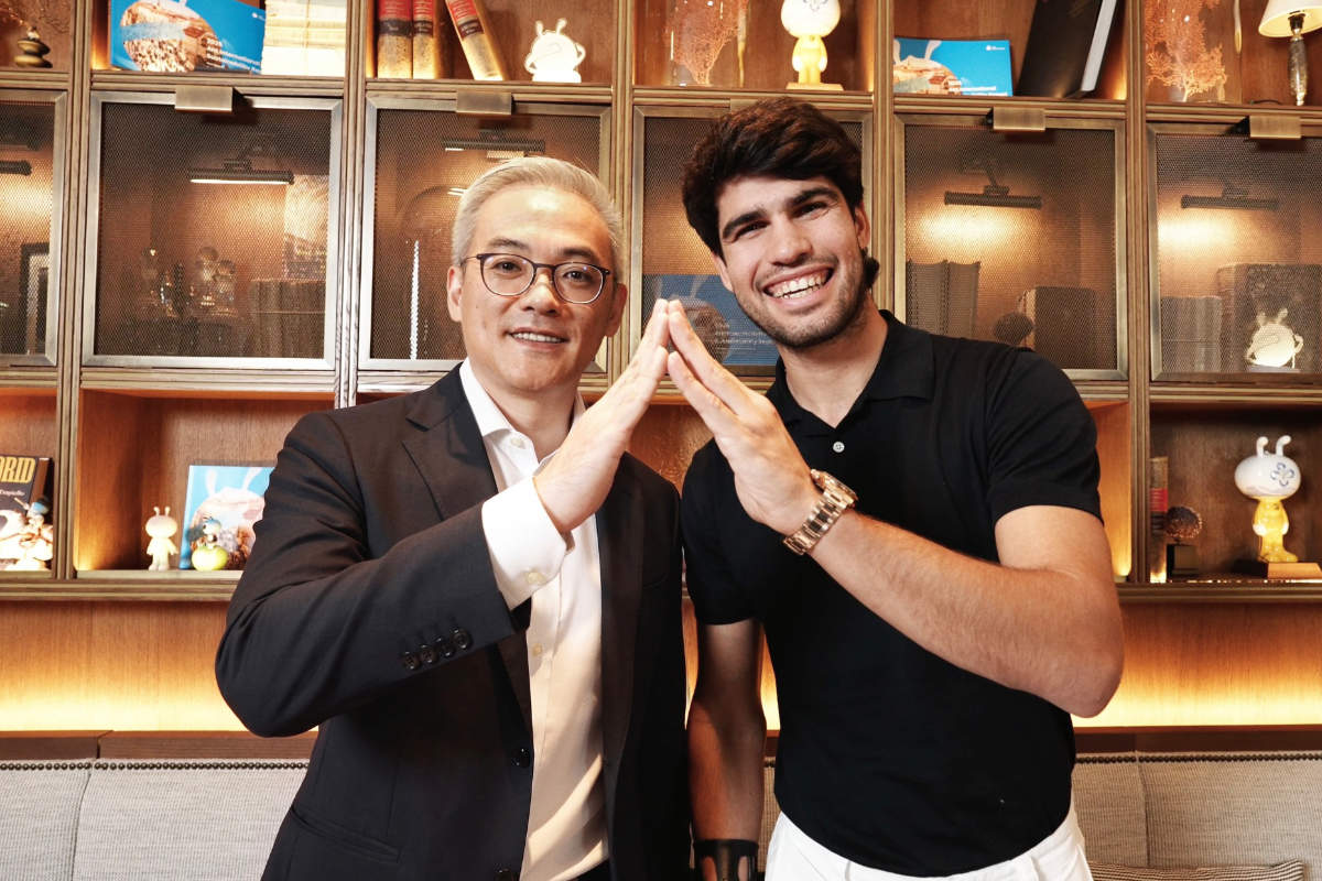 Peng Yang on the left with Carlos Alcaraz, celebrating their brand partnership