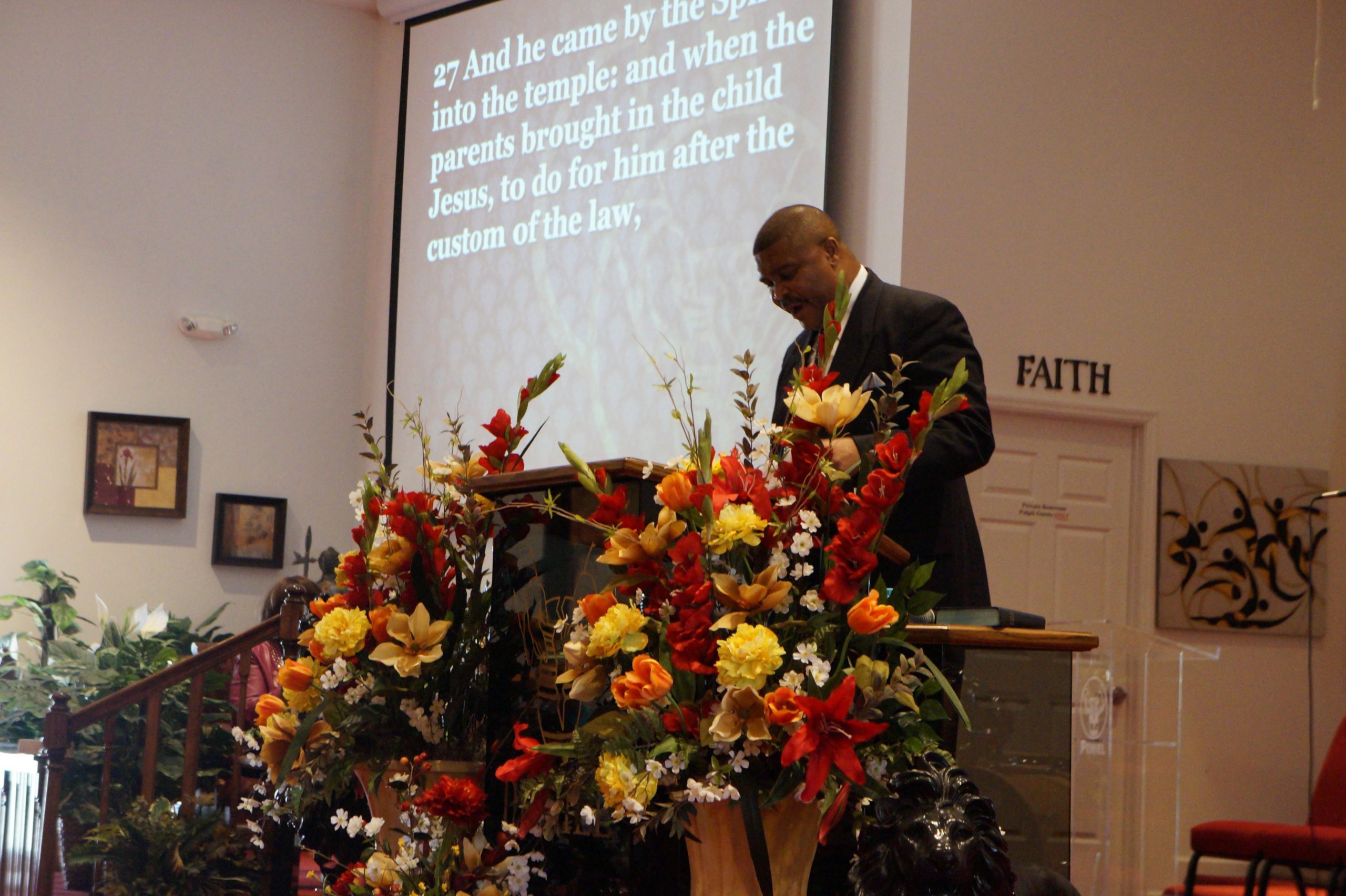 A preacher at the lectern inside Peniel Praise Community Church