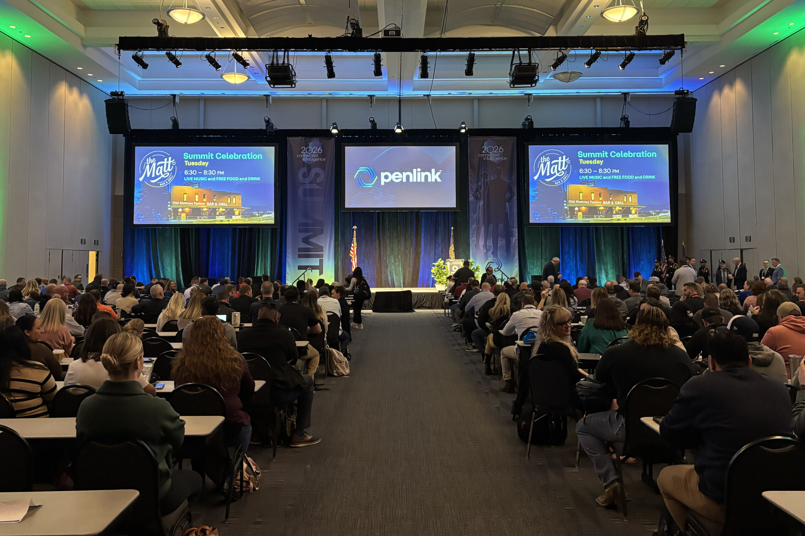 Audience and blue-lit main stage at the 2026 Penlink Training Summit