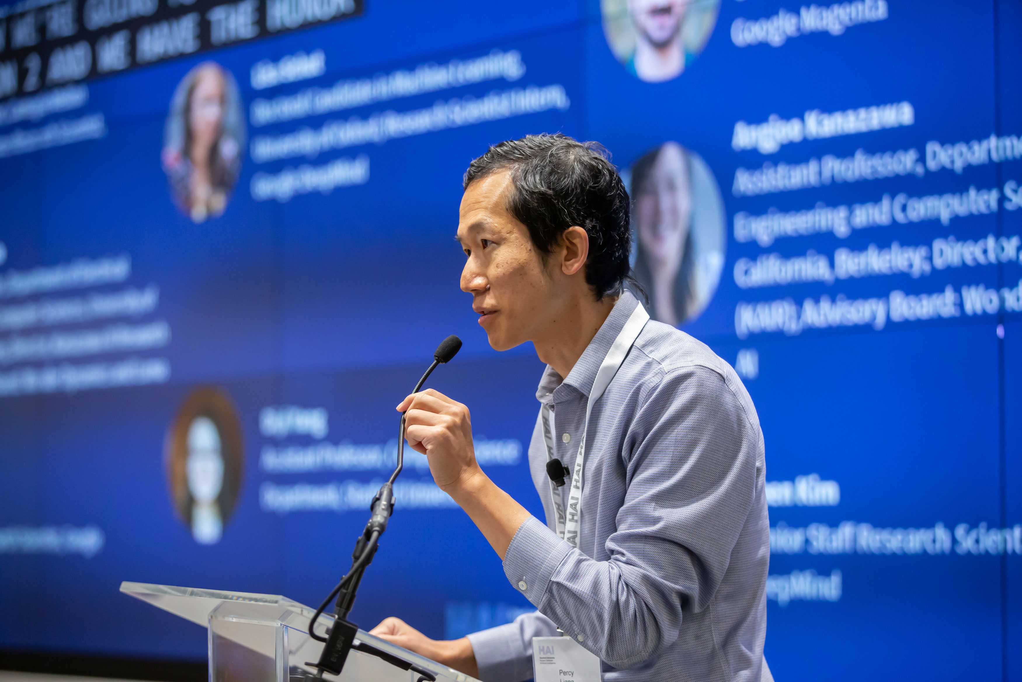 Percy Liang speaking at a Stanford HAI conference podium