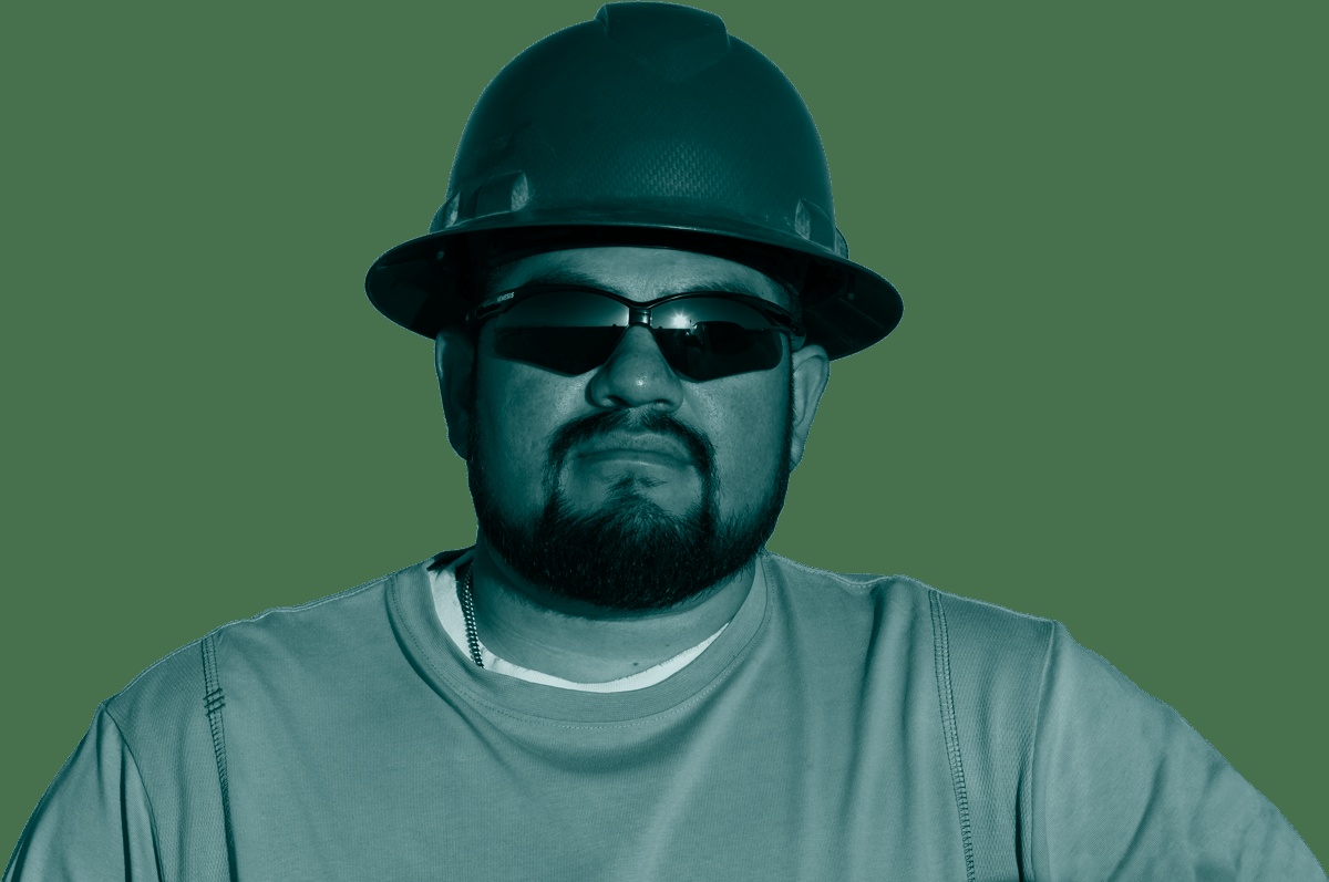 A worker wearing a hard hat and safety glasses in the company’s teal-toned careers imagery