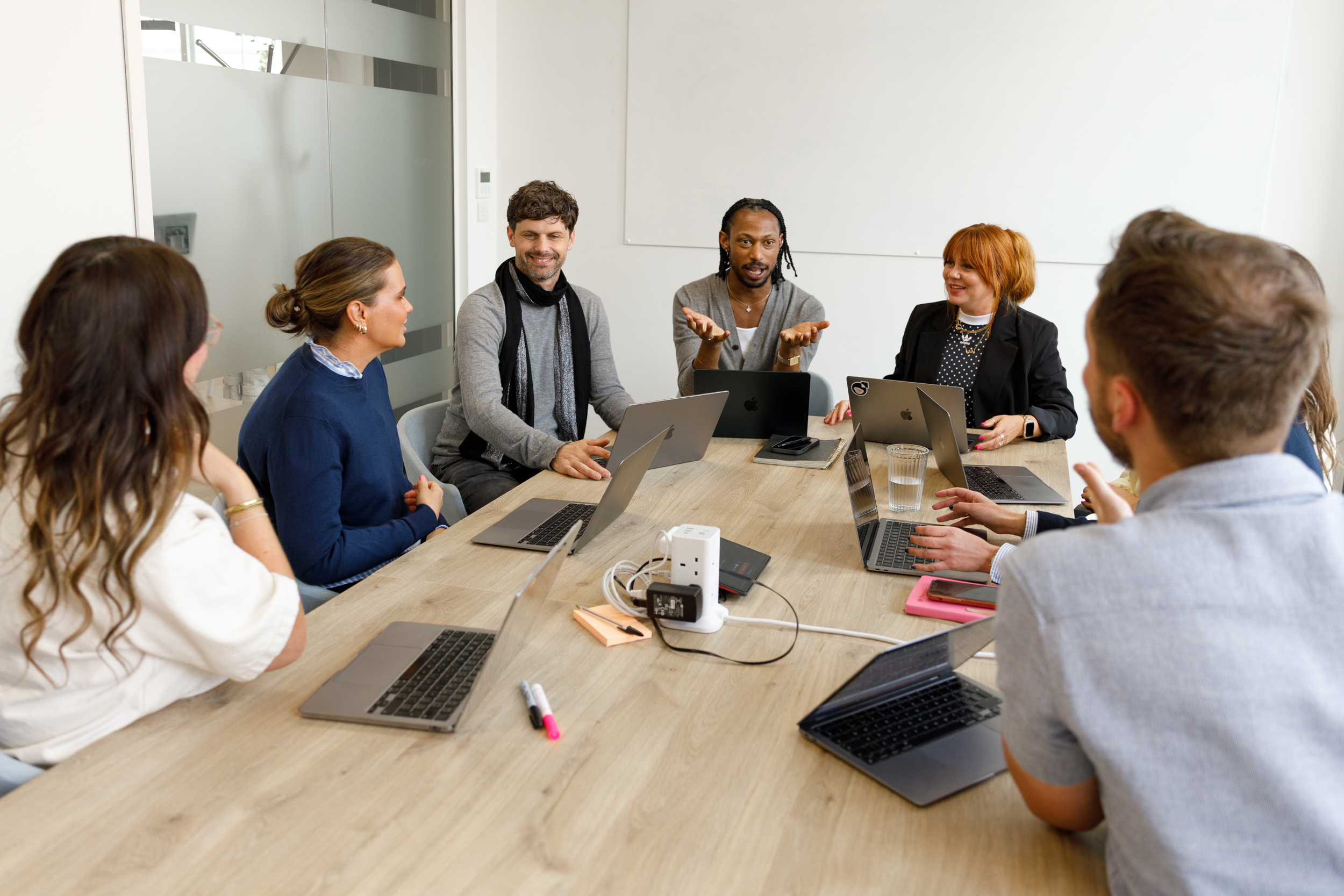 Permutive colleagues discussing work around a conference table in London