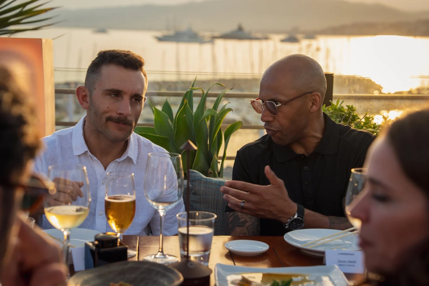 Pete Birsinger seated at an outdoor dinner table during Podscribe’s Cannes Lions gathering