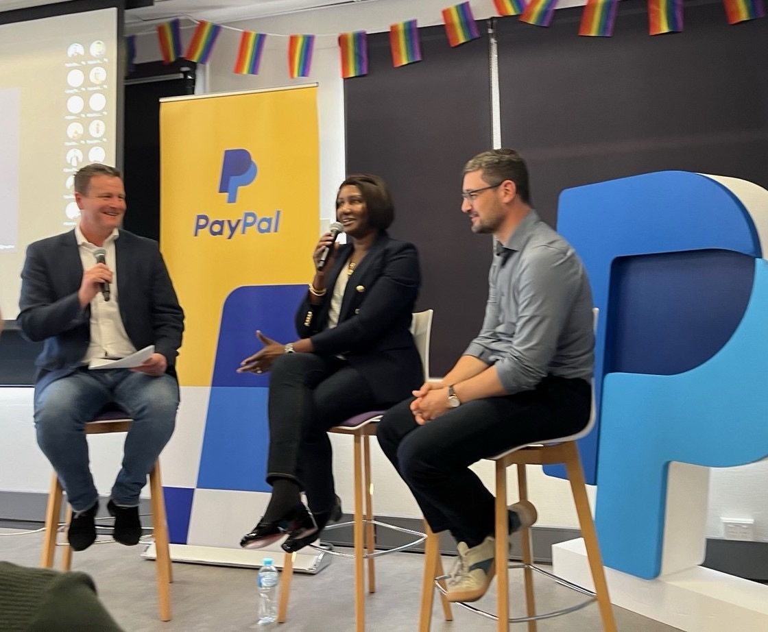 Peter Cowan, at left holding a microphone, in a seated discussion with PayPal colleagues in the Sydney office