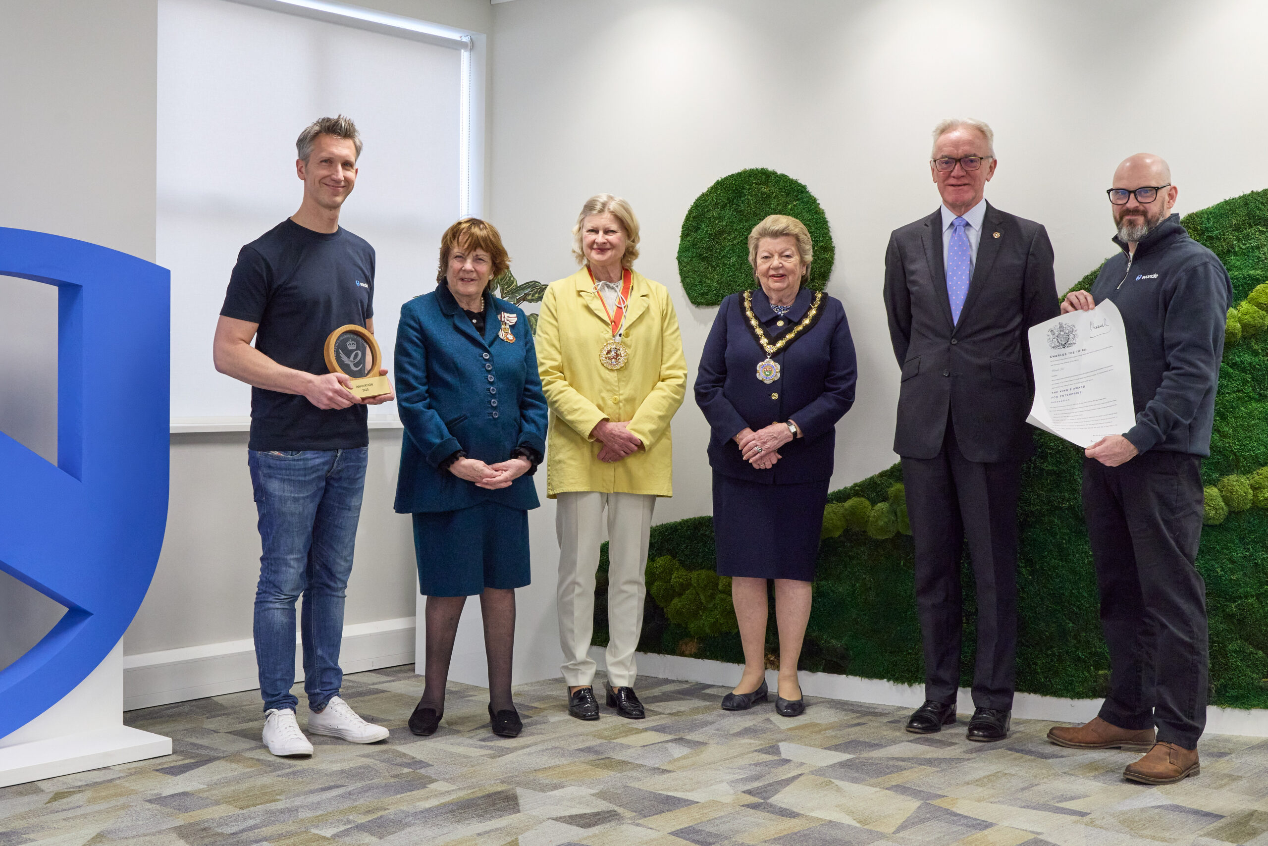 Peter Dabrowa, at left, holding Wonde’s innovation award alongside the Lord-Lieutenant of Suffolk and fellow guests