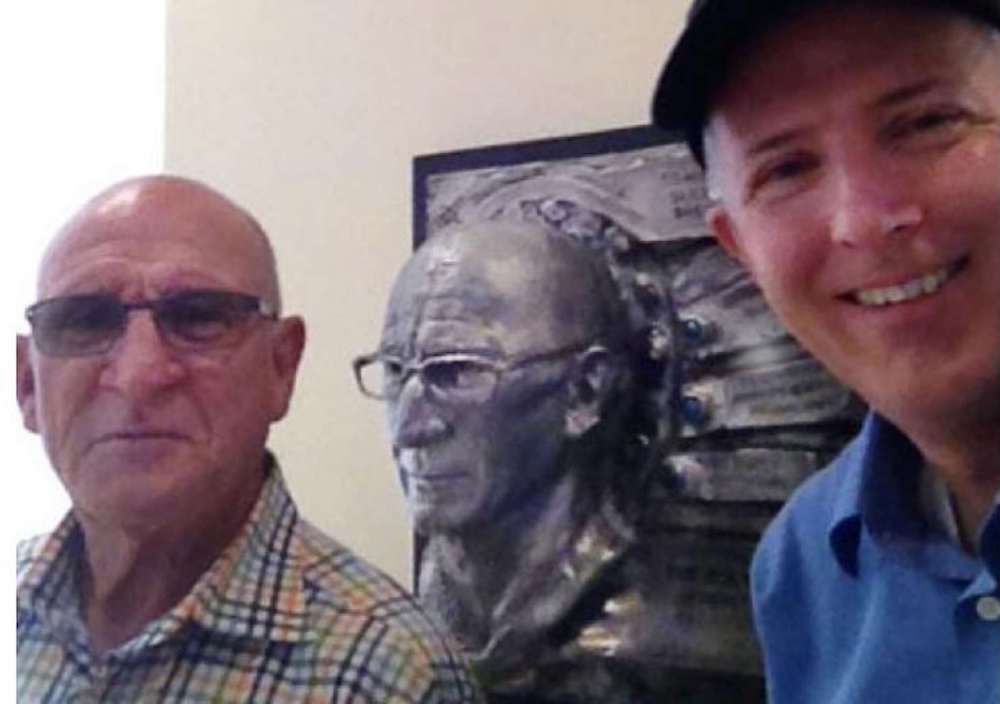 Peter Farrell, left, with sculptor Richard Becker beside a metal portrait of Farrell at ResMed