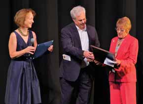 Sarah Finn, Peter Finn and Kay Stamer onstage at an arts award presentation