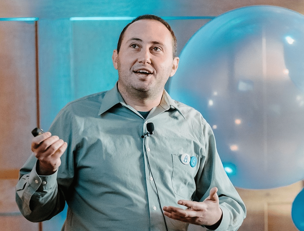 Peter Fishman, co-founder and CEO of Mozart Data, mid-gesture on stage