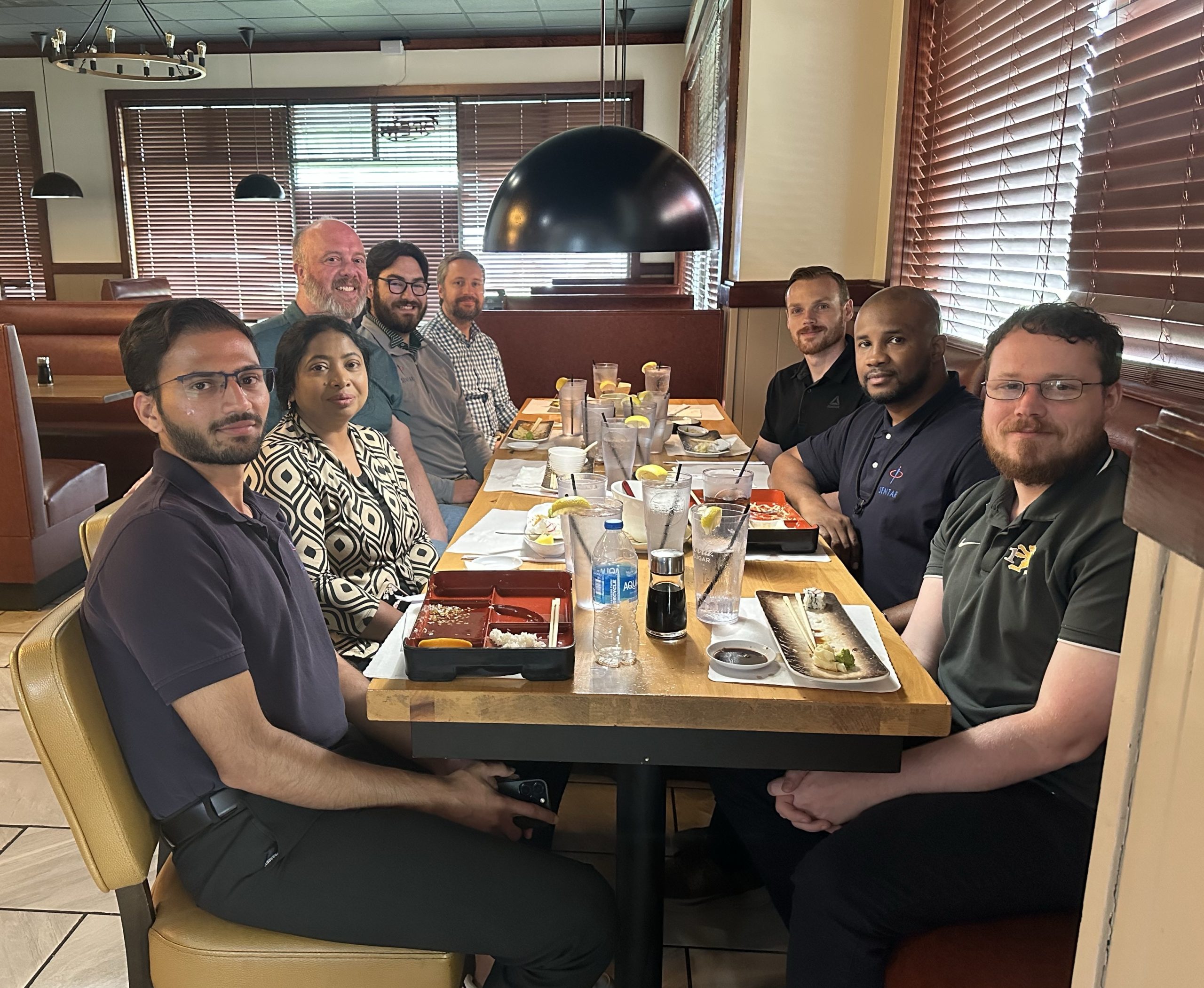 Sentar colleagues gathered around a restaurant table for lunch