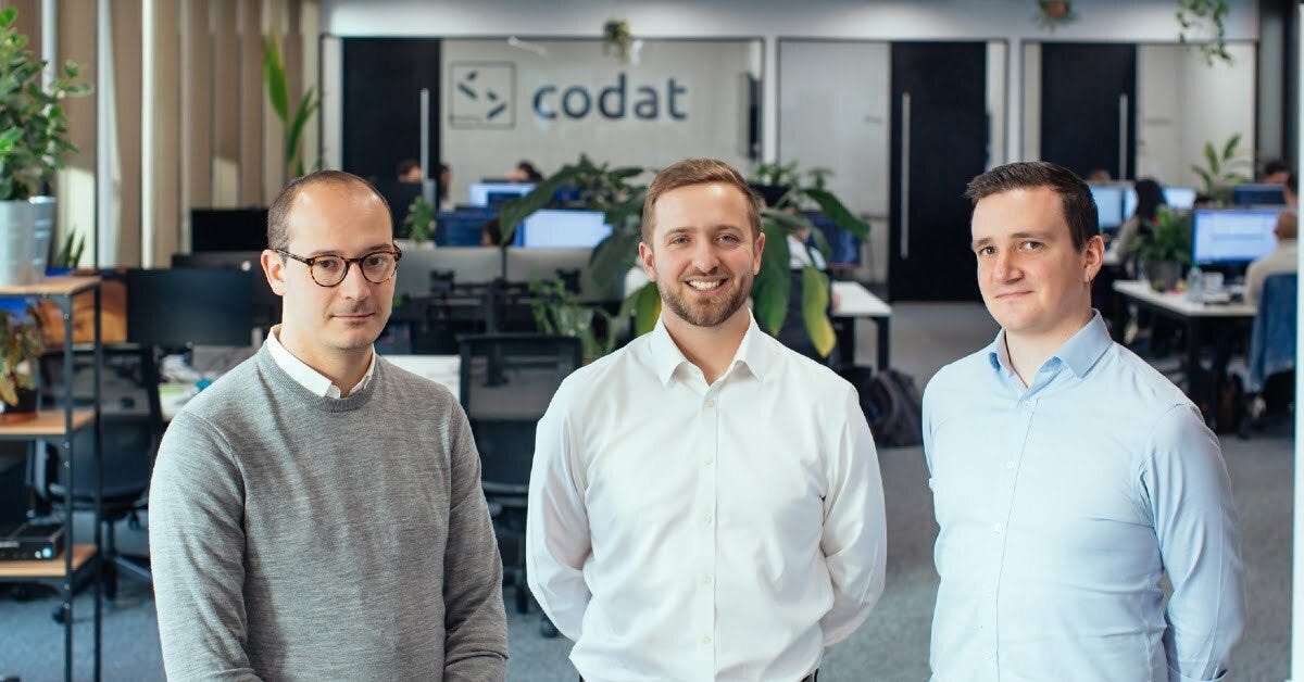 Codat co-founders Alex Cardona, Peter Lord and David Hoare standing together in their office