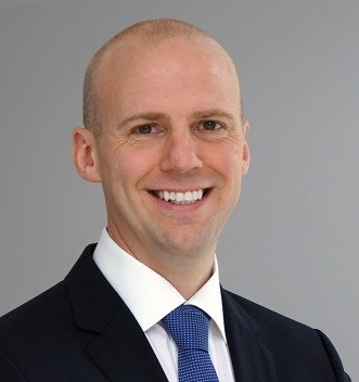 Peter Nilsson in a dark suit and blue tie