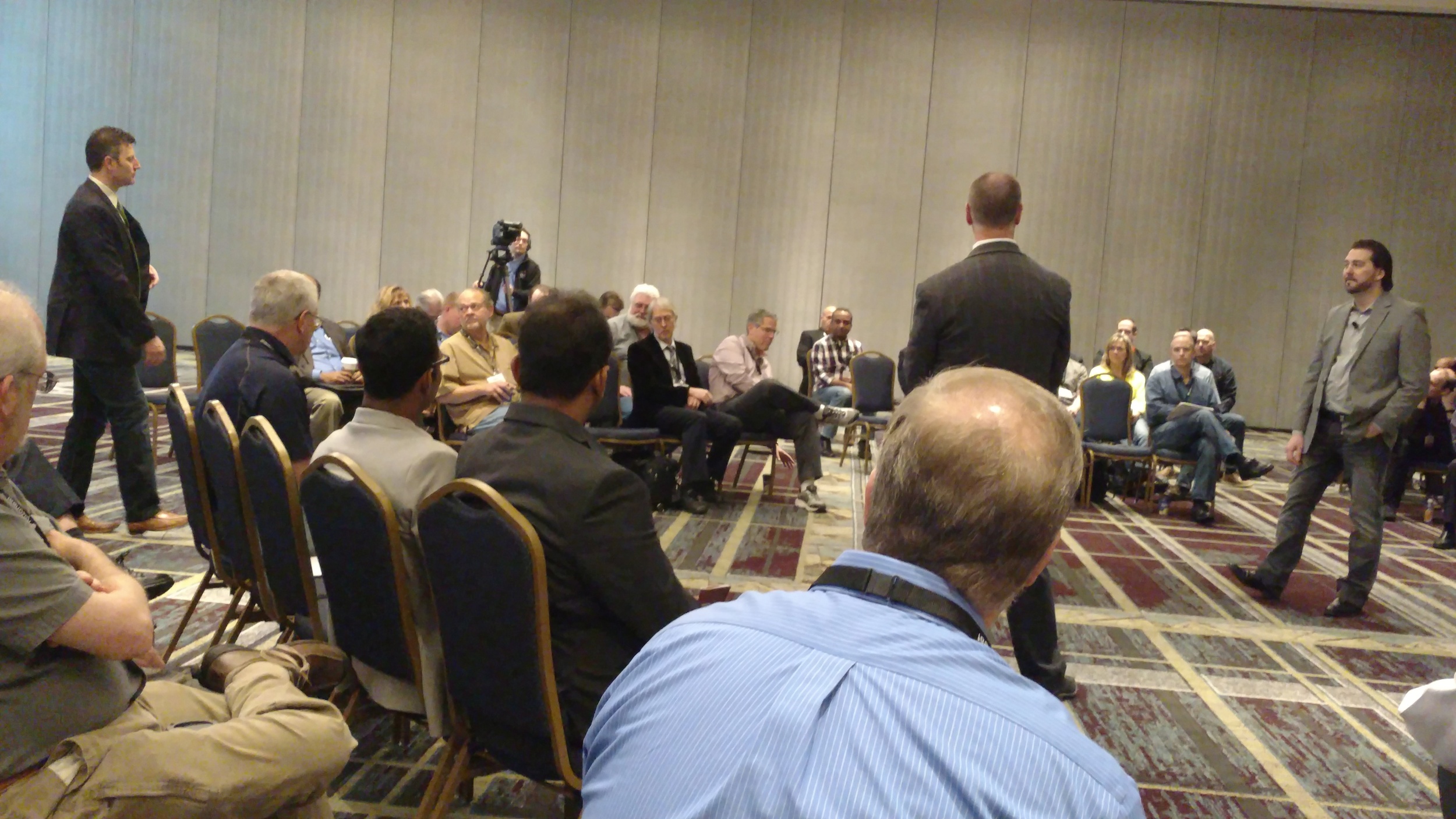 Attendees gather around a boxing-ring setting for Aras in the Round at ACE 2016