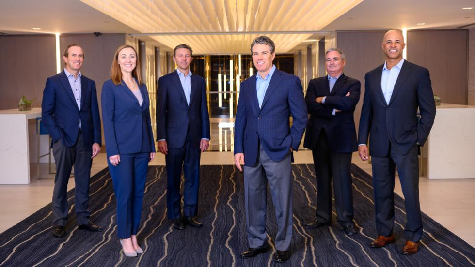 Peter Scott, far left, with five fellow Healthpeak executives in an office lobby