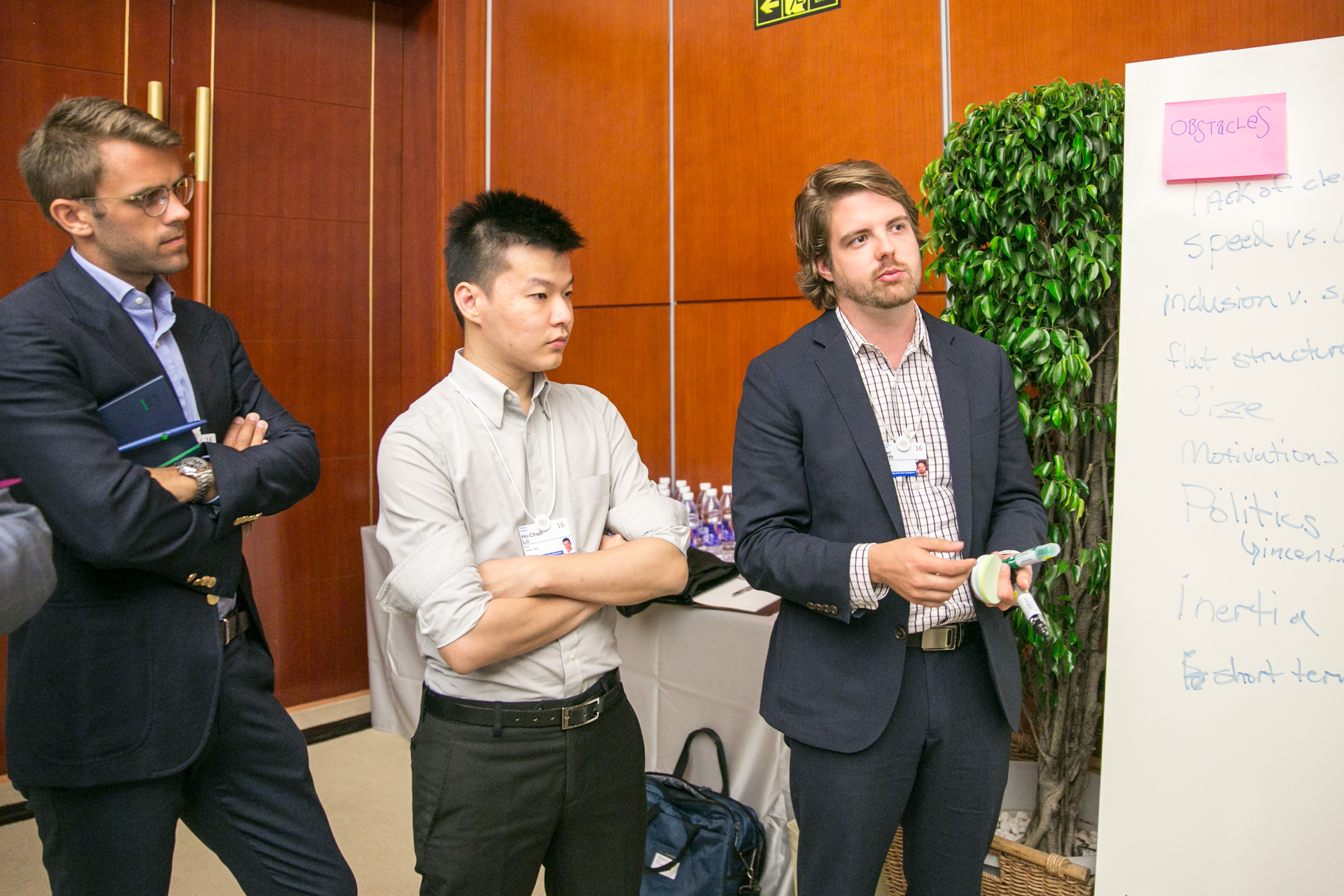 Peter Smith, at right, holding markers beside a workshop flip chart at the World Economic Forum in Tianjin in 2016