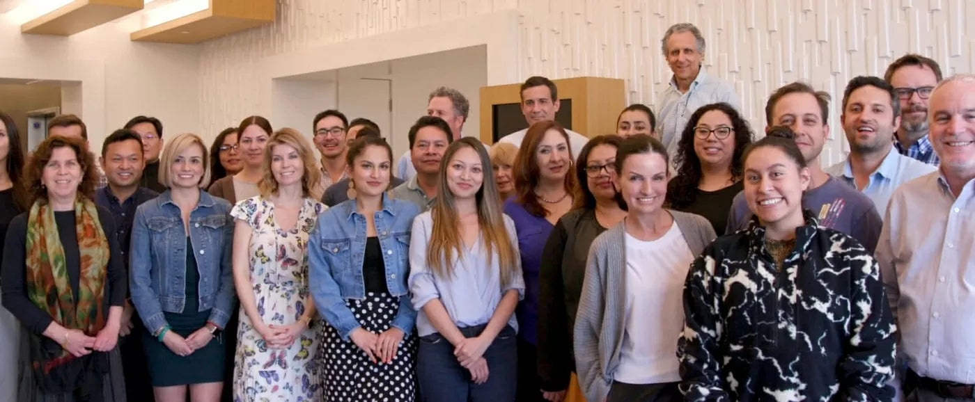 Peter Spiegel standing in the back row with the Ideal Living team