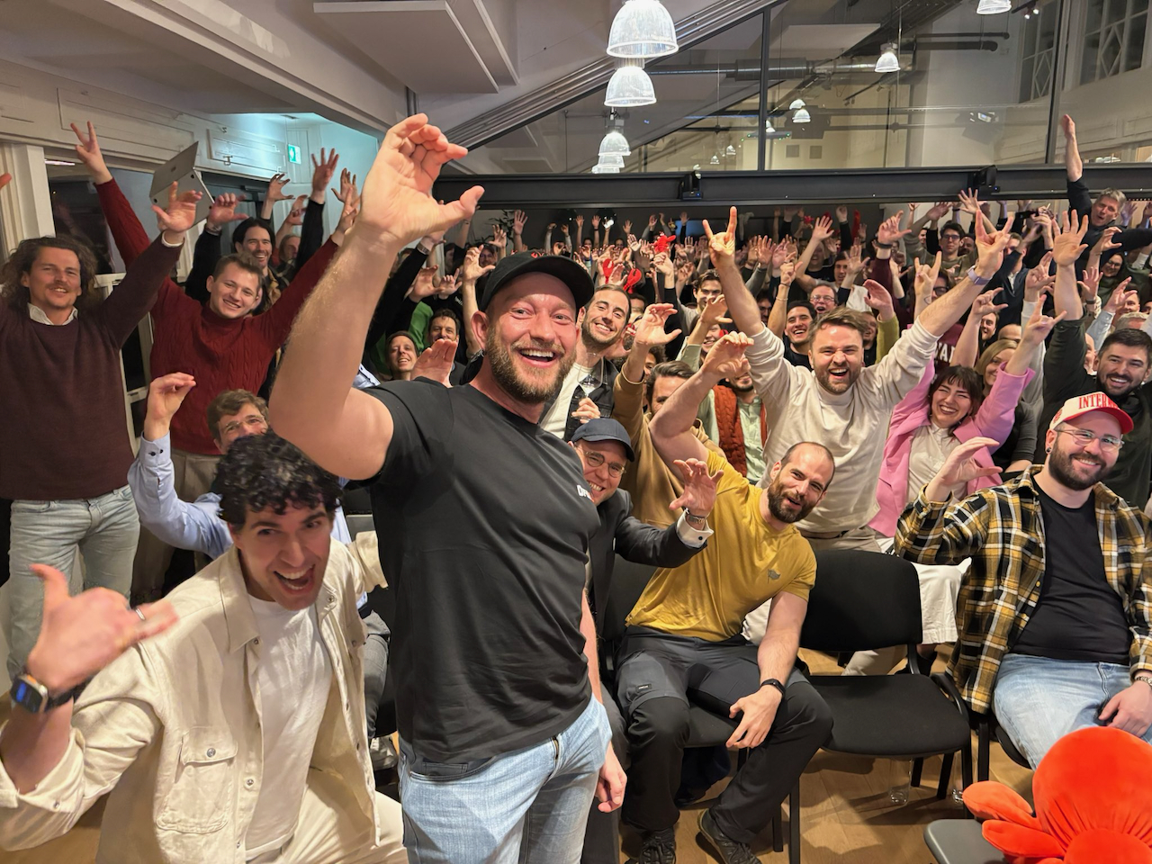 Peter Steinberger smiling with a crowd at a ClawCon gathering