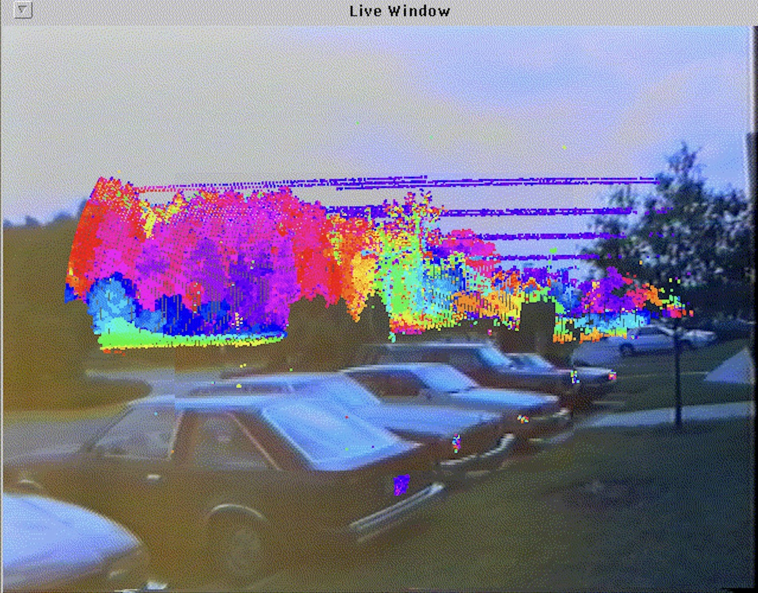 A street scene overlaid with colored LiDAR measurements