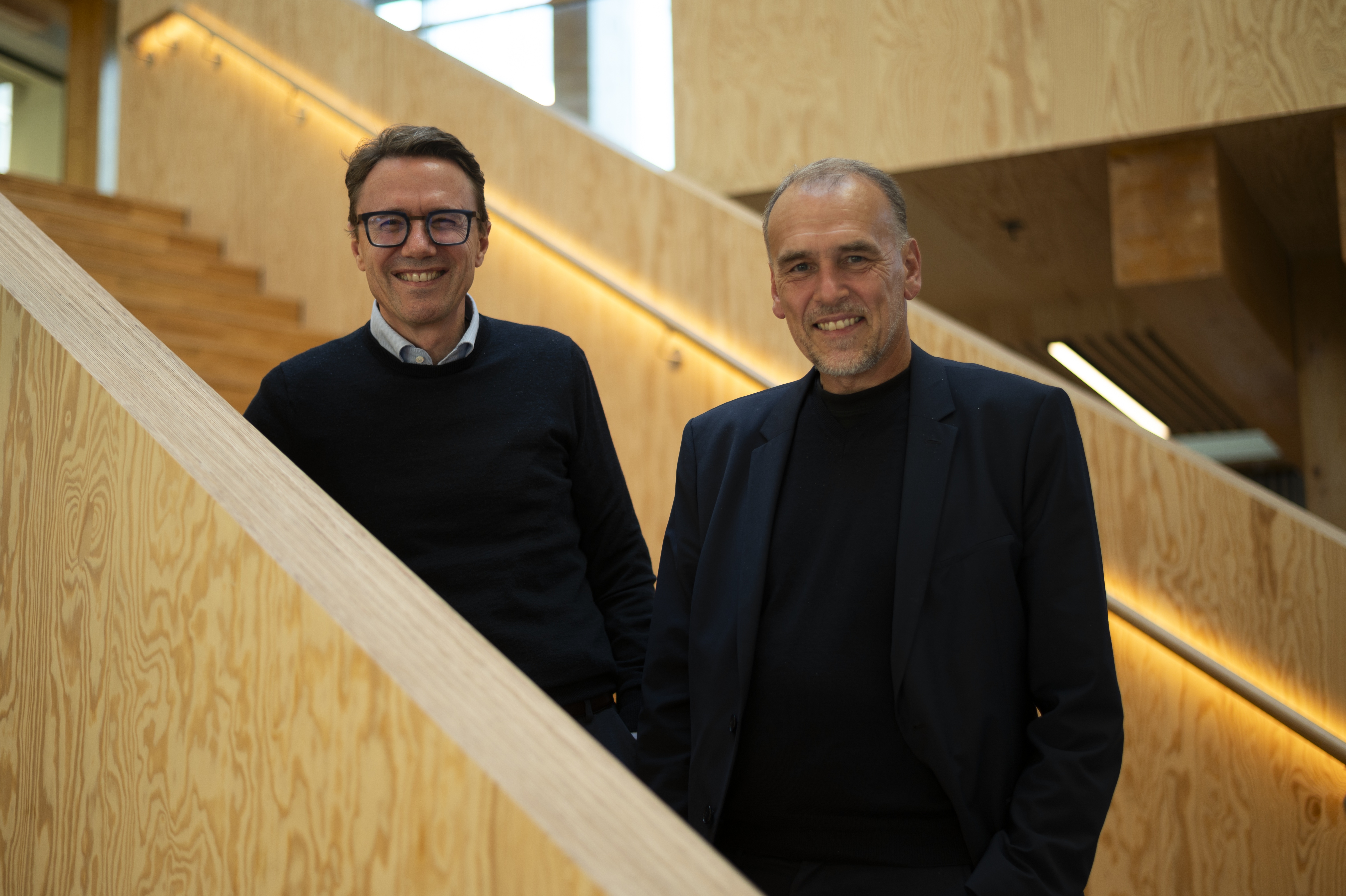 Jens Nielsen, left, and Peter Torstensen, right, standing together on a wooden staircase.