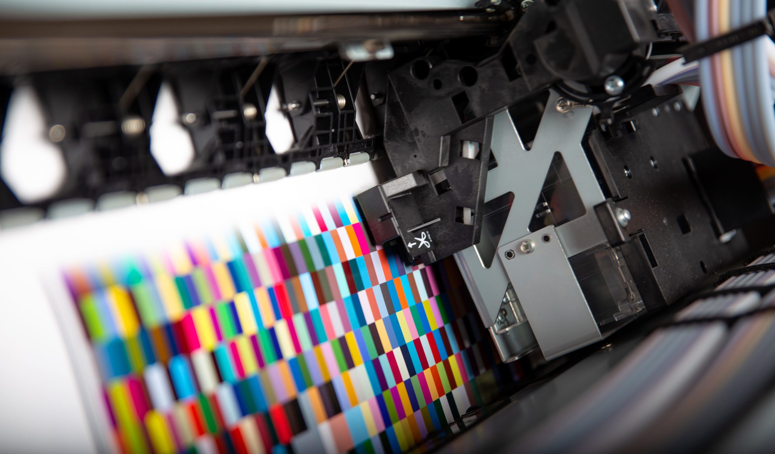 A commercial printer producing a bright color calibration pattern