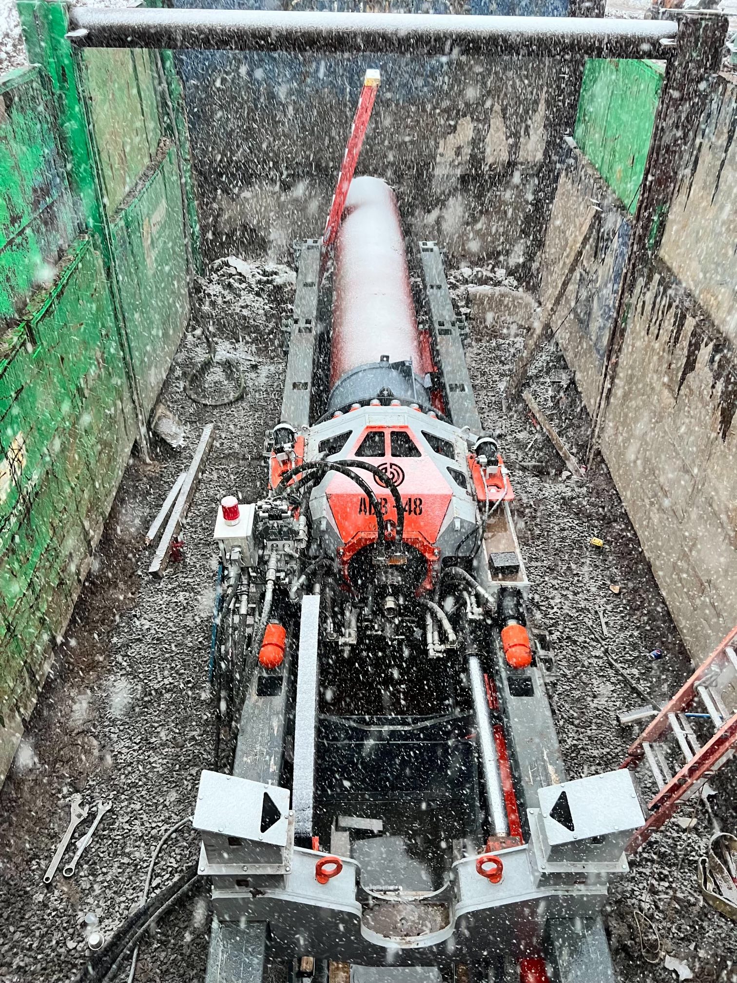 Petra’s red and gray trenchless platform in a shored excavation during snowfall in New York