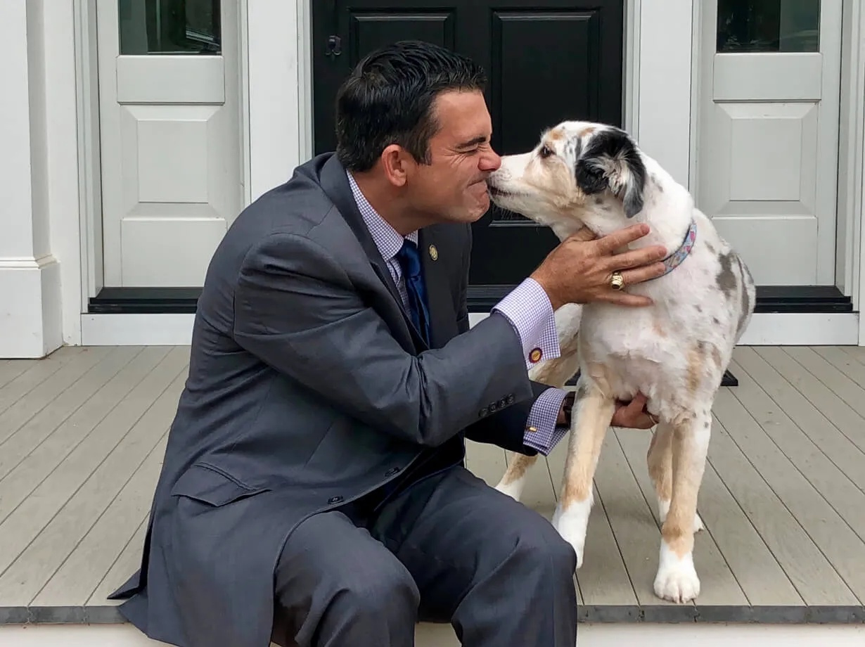 PetScreening founder John Bradford receiving a lick from his dog