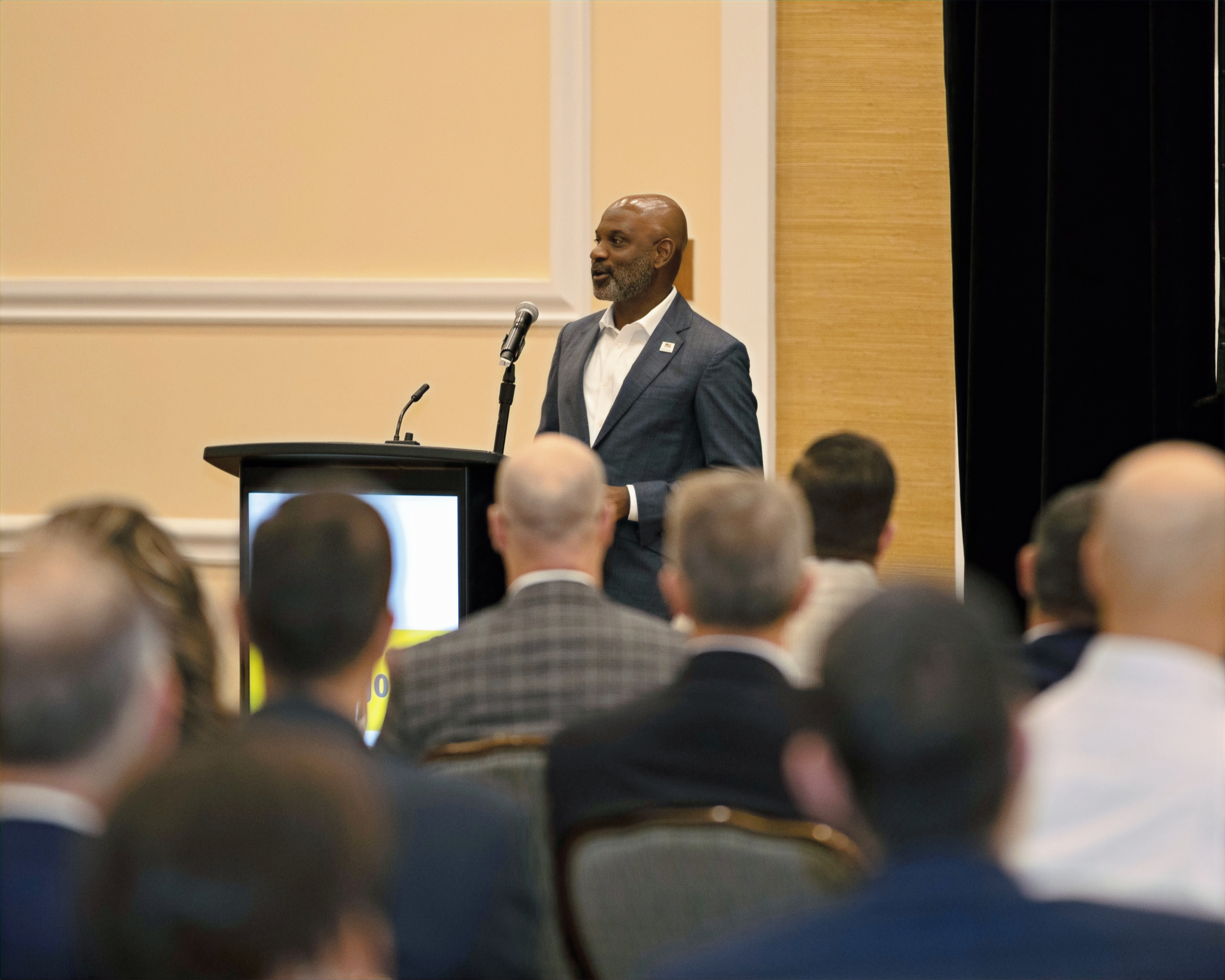 Lamell McMorris speaking at a lectern to an audience