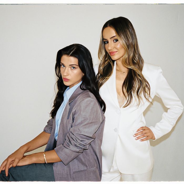 Phia co-founders Phoebe Gates and Sophia Kianni posing together in tailored suits